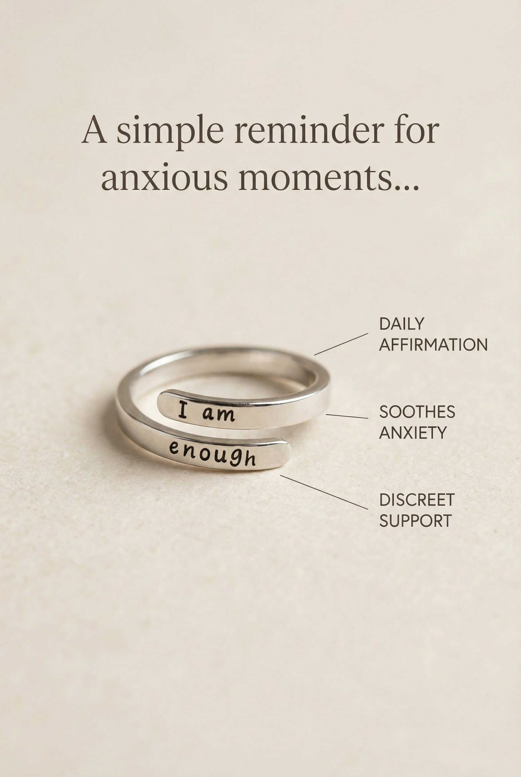 Silver ring with 'I am enough' engraving on a beige background