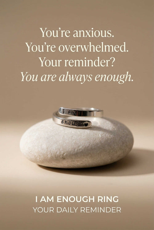 Silver ring on a stone with motivational text on a beige background